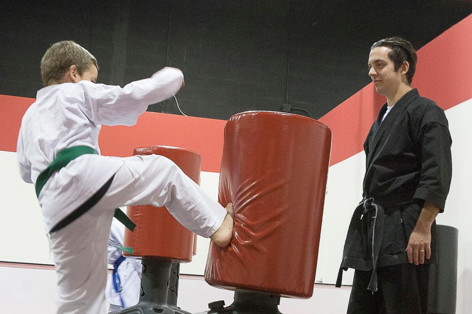 Teen karate student kicking a bag at Prodigy dojo