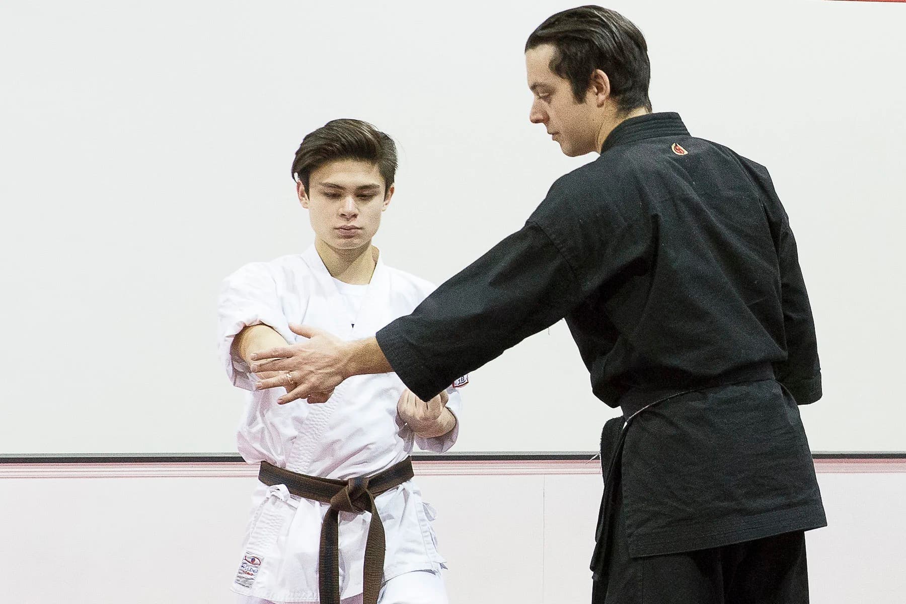 Instructor correcting a student's technique